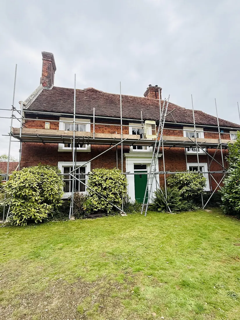Scaffolding across a red-brick period house