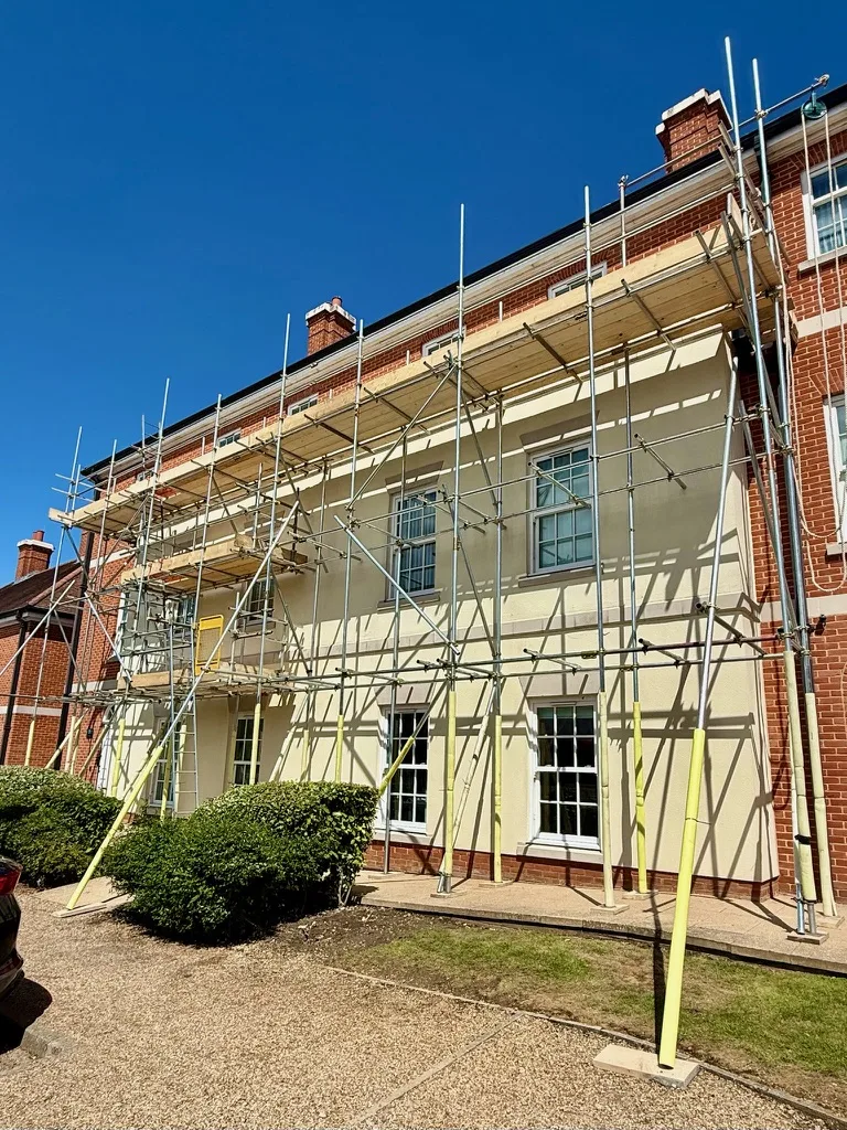 Scaffolding on a large rendered and red-brick house in Essex by Falcon Scaffolding